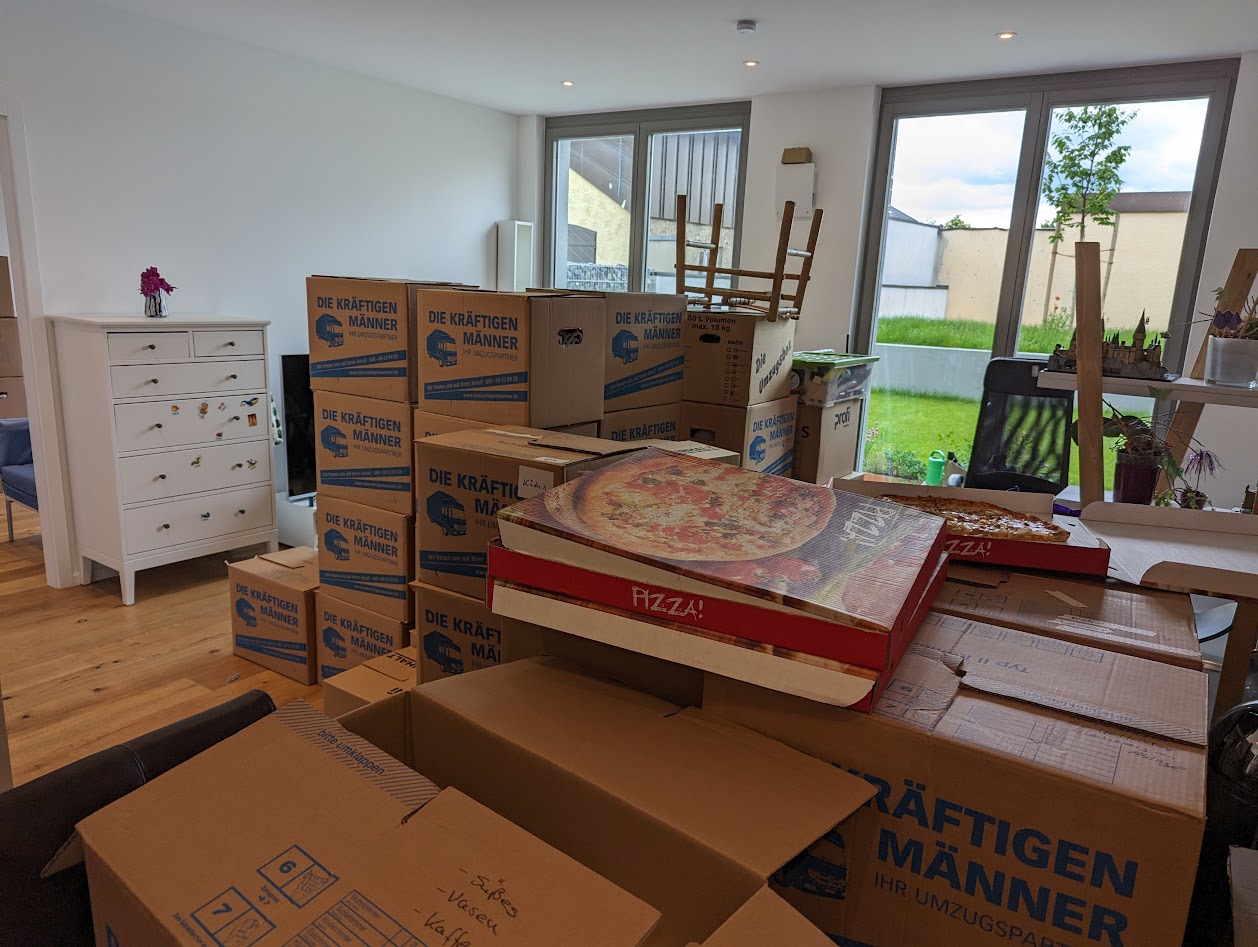 Moving day and all the boxes are everywhere, small garden in the back.