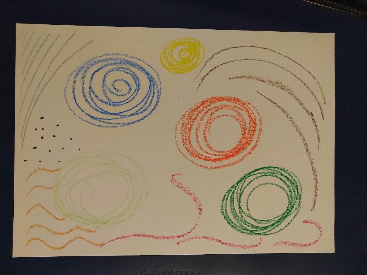 Painting with wax crayons, mainly circles.